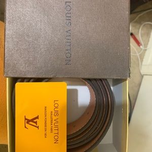 Brown and tan Louis Vuitton belt with a small rip